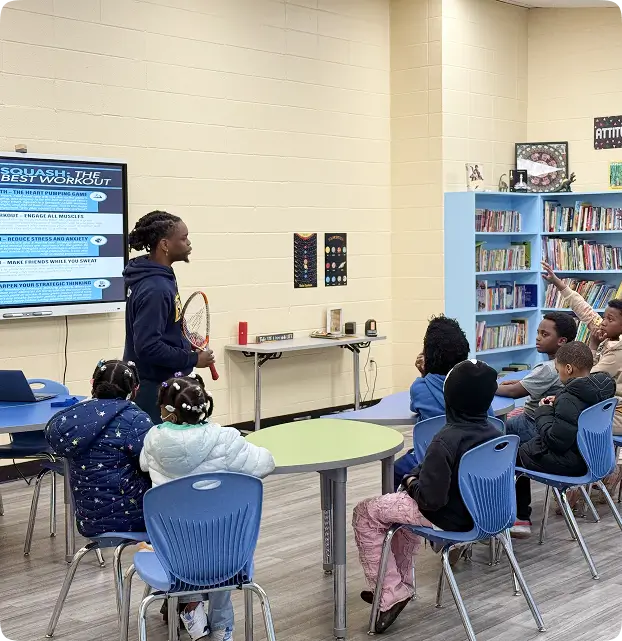 Coach Kay Zee Sitshebo of Louisville Squash Plus teaches students about the game of Squash