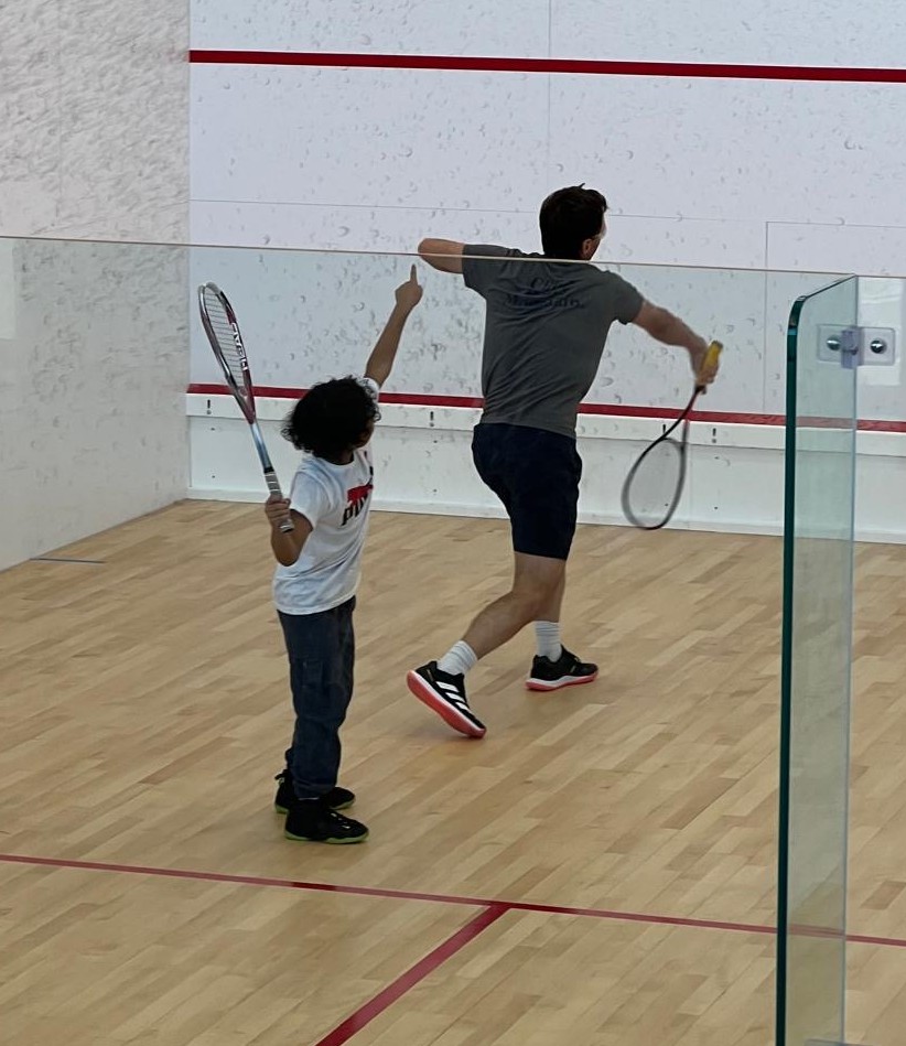 Cropped action shot 2f6f6964-6ee0-4cf4-97c0-ce510a583025 Community squash players in action on court